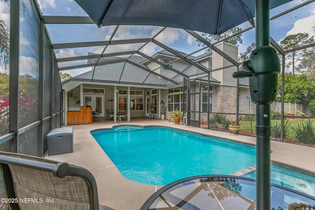 outdoor pool with a patio, french doors, and a lanai