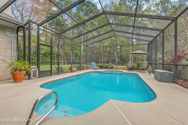 pool with glass enclosure and a patio