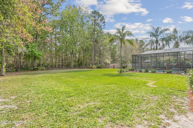 view of yard with glass enclosure