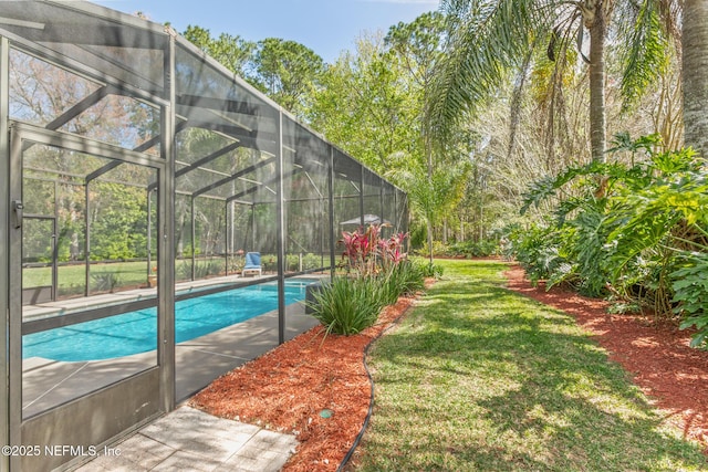 pool featuring a lawn and a lanai