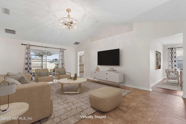 living area featuring a chandelier, visible vents, and vaulted ceiling