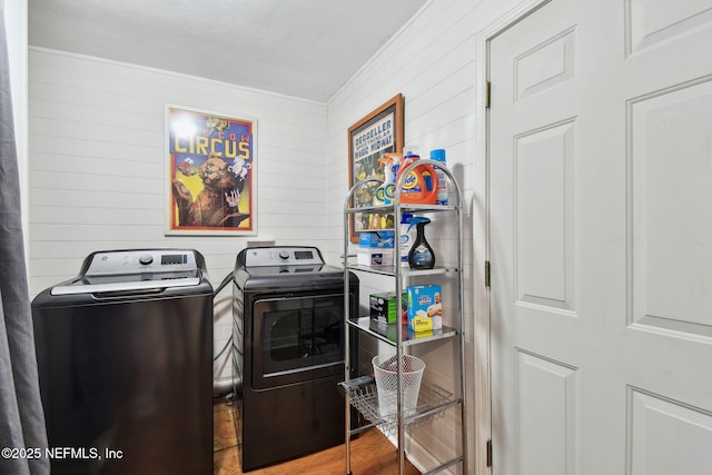 washroom featuring washing machine and clothes dryer and wood-type flooring