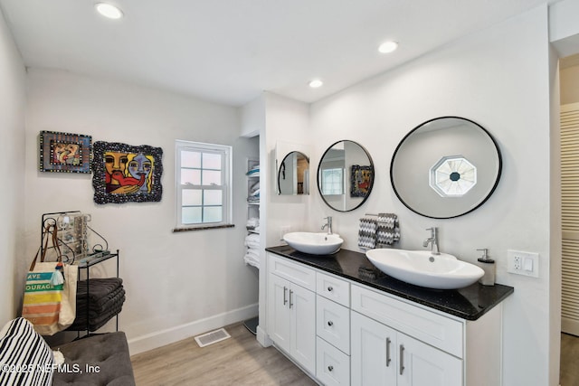 bathroom with vanity and wood-type flooring