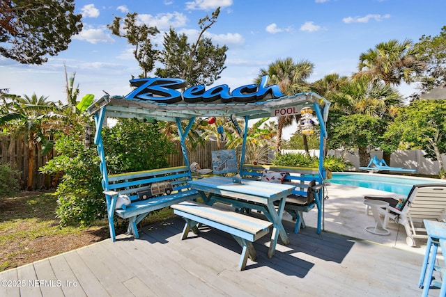 wooden terrace featuring a pergola and a fenced in pool