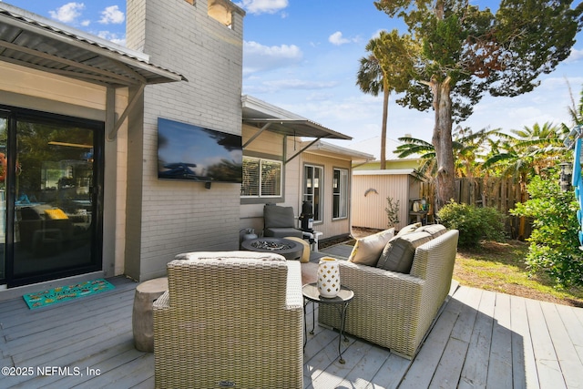 wooden terrace featuring an outdoor fire pit