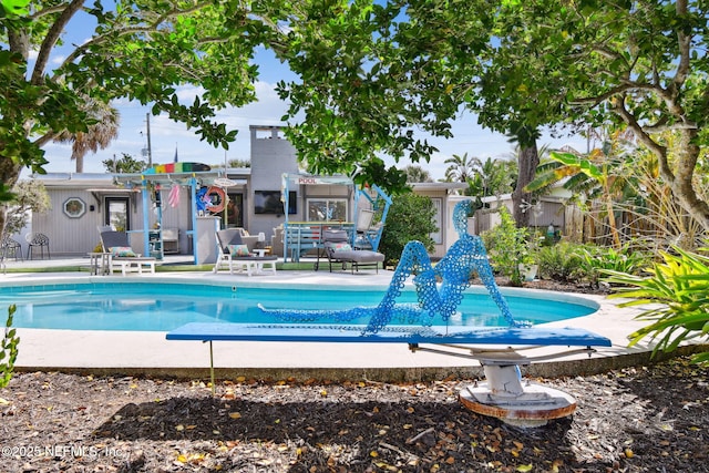 view of swimming pool with a patio area