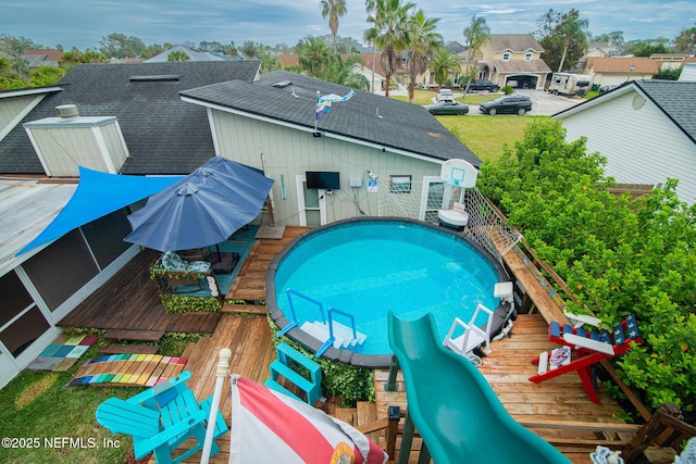 view of swimming pool with a fenced in pool, a residential view, and a wooden deck