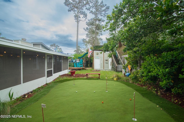 view of yard featuring stairway and a sunroom