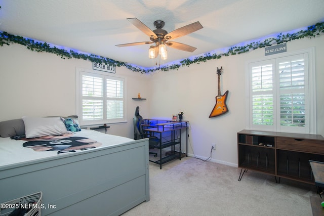 bedroom featuring ceiling fan, baseboards, and light carpet