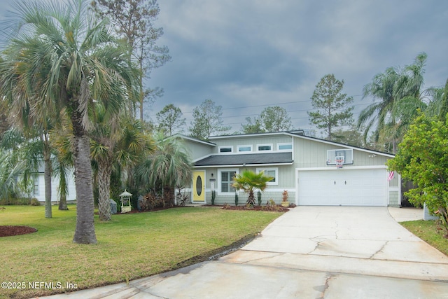 mid-century home with a garage, a front lawn, and driveway