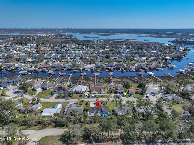 drone / aerial view with a residential view and a water view