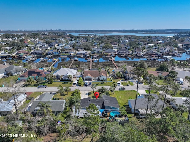 birds eye view of property with a residential view and a water view