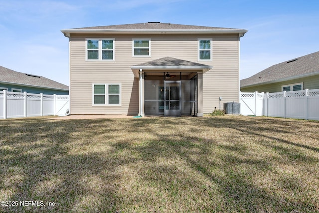 back of house with a sunroom, a fenced backyard, and a lawn