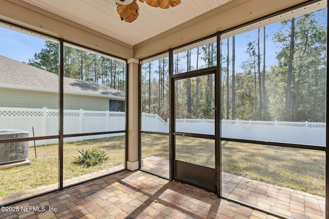 unfurnished sunroom with ceiling fan