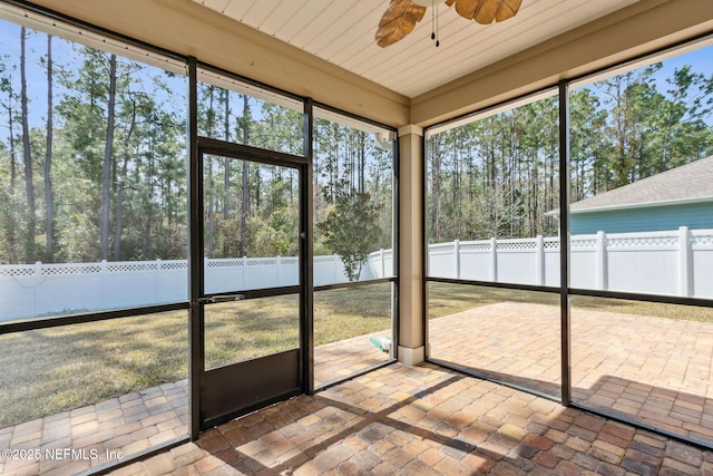 unfurnished sunroom with a ceiling fan