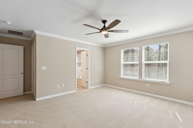 unfurnished bedroom featuring visible vents, ornamental molding, light carpet, a textured ceiling, and baseboards