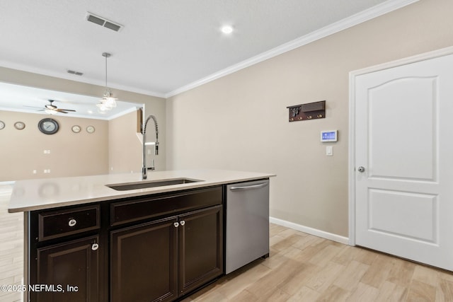 kitchen with crown molding, light countertops, visible vents, a sink, and dishwasher