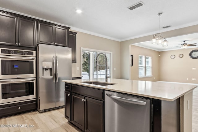 kitchen with a sink, visible vents, light countertops, appliances with stainless steel finishes, and a wealth of natural light