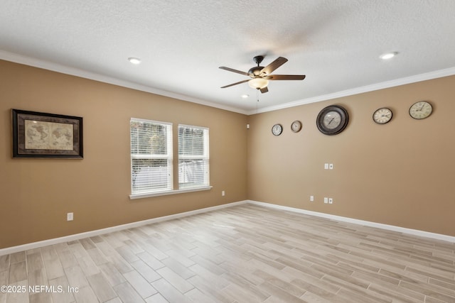 empty room featuring ornamental molding, light wood-type flooring, a ceiling fan, and baseboards