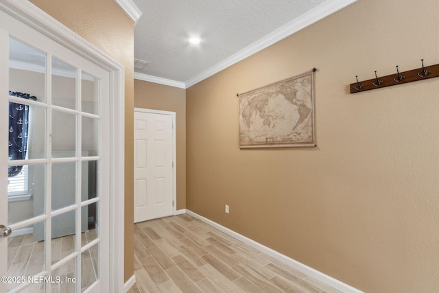 unfurnished room featuring baseboards, light wood-type flooring, and crown molding