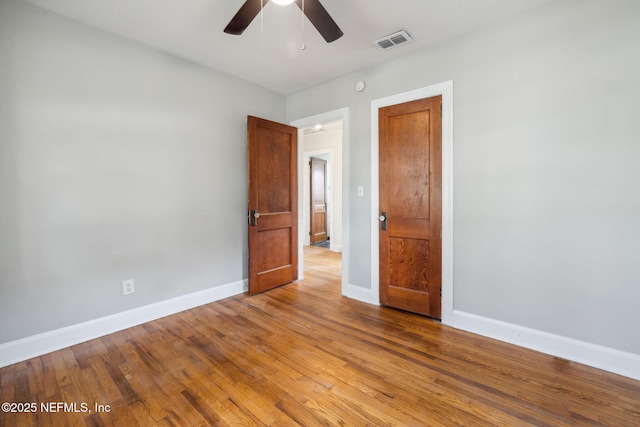 unfurnished room featuring light wood-type flooring and ceiling fan