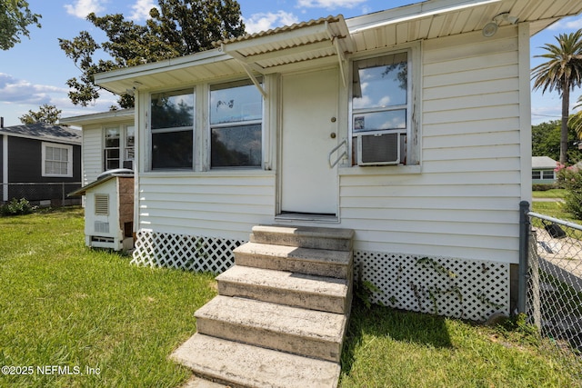 view of front of house with a front lawn and cooling unit