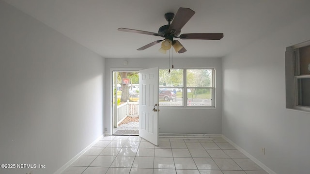 doorway featuring light tile patterned flooring and ceiling fan