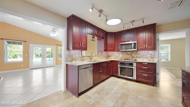 kitchen featuring french doors, stainless steel appliances, visible vents, a sink, and dark brown cabinets