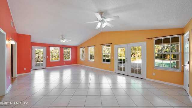 unfurnished room featuring french doors, light tile patterned floors, visible vents, a ceiling fan, and vaulted ceiling