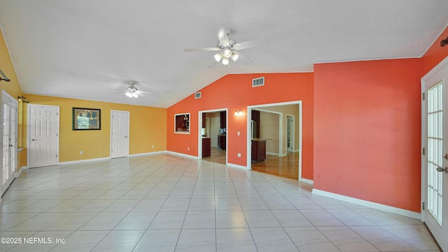 unfurnished room featuring light tile patterned floors, visible vents, baseboards, ceiling fan, and vaulted ceiling