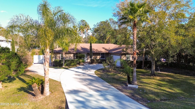 ranch-style house featuring a front yard and driveway