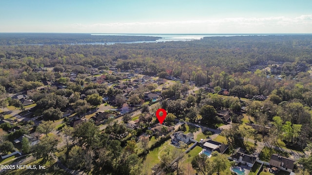 birds eye view of property featuring a water view and a forest view