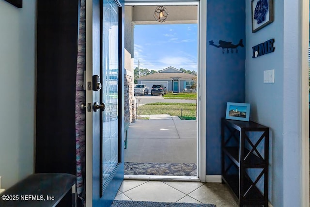 doorway to outside with tile patterned flooring