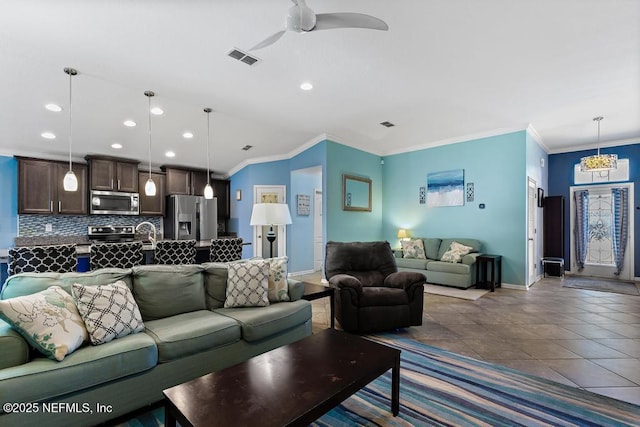 tiled living room with crown molding and ceiling fan