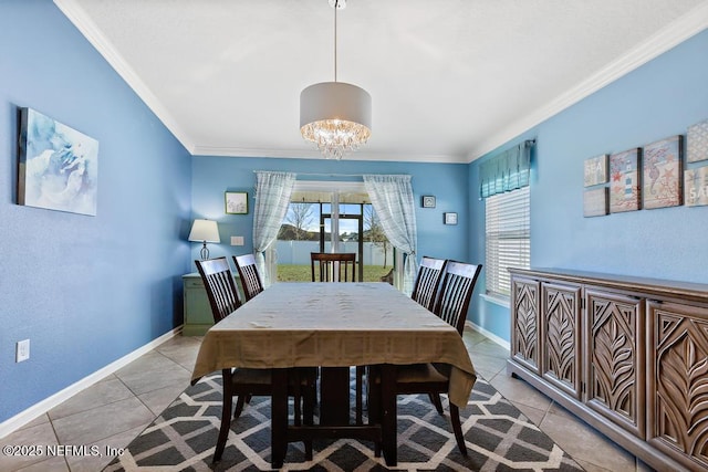 tiled dining area with crown molding and an inviting chandelier