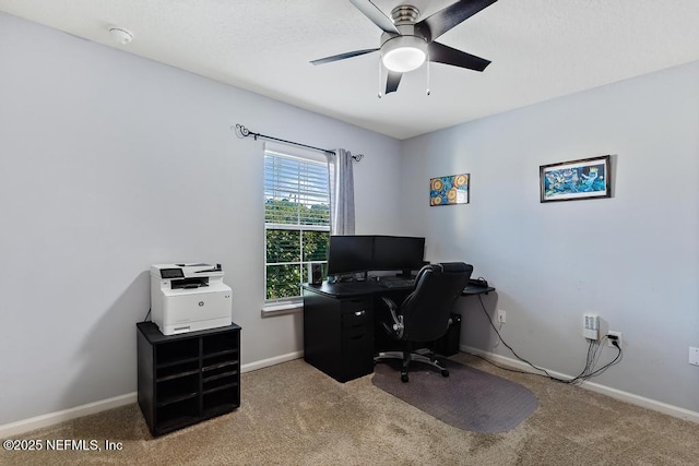 carpeted office space featuring ceiling fan