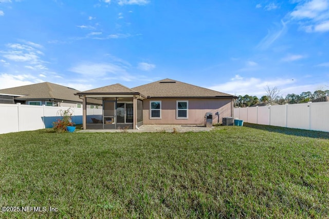 rear view of property with a yard, a patio, and cooling unit