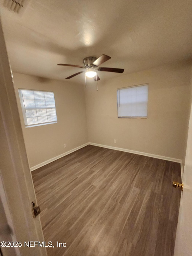 spare room with ceiling fan, baseboards, and wood finished floors