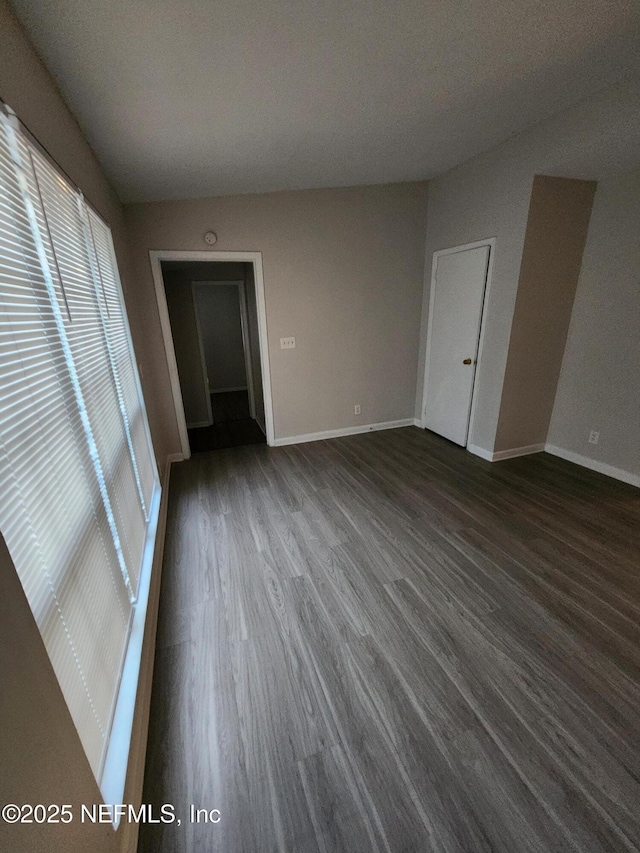 unfurnished room featuring wood finished floors and baseboards