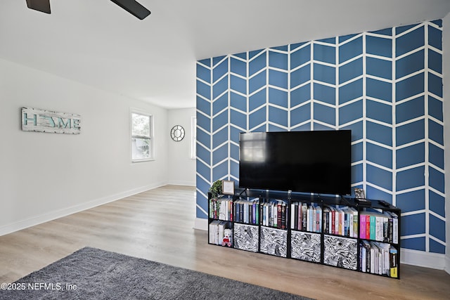 living room featuring baseboards and wood finished floors