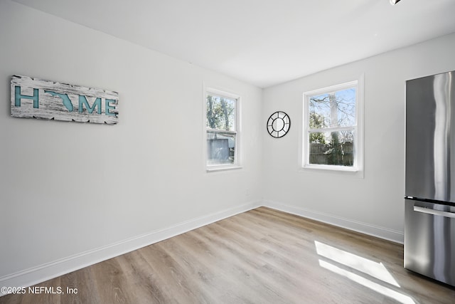 empty room with wood finished floors and baseboards