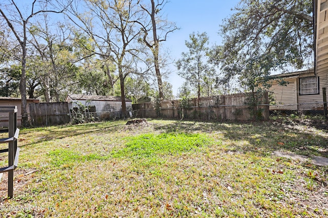 view of yard with a fenced backyard