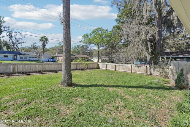 view of yard with a fenced backyard