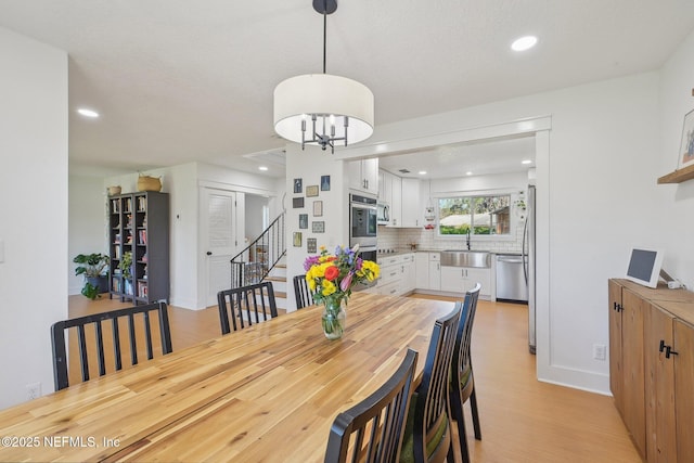 dining room with recessed lighting, a chandelier, and light wood finished floors