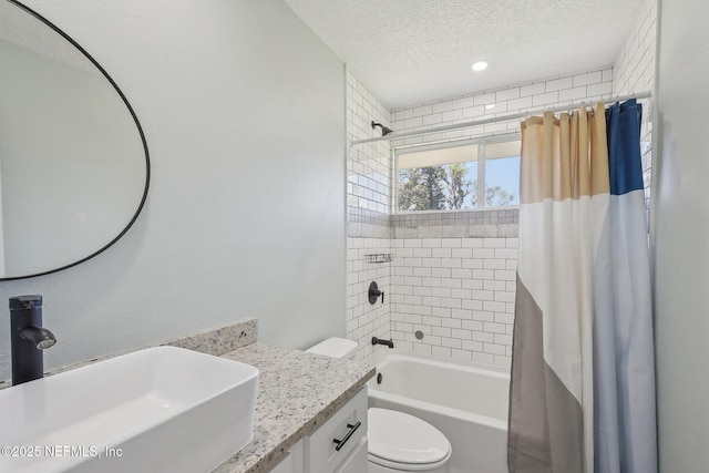 full bathroom with a textured ceiling, shower / bath combo, vanity, and toilet