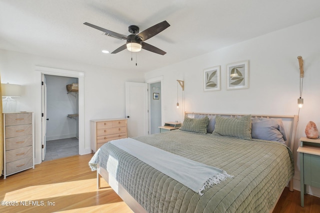 bedroom featuring a ceiling fan and light wood finished floors