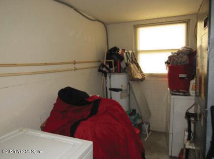 interior space with water heater and washing machine and clothes dryer