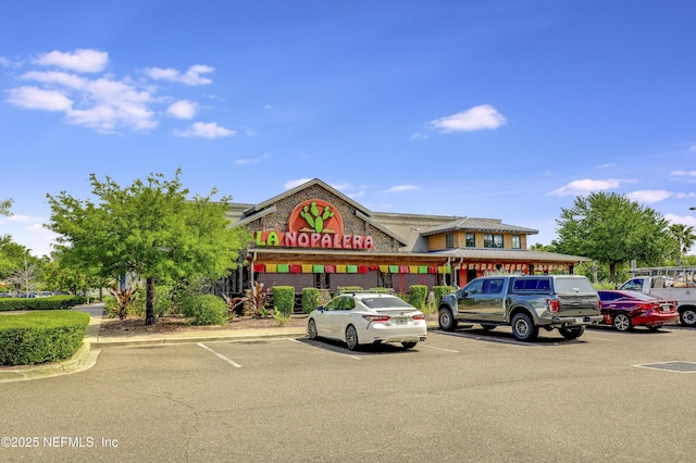 view of property with uncovered parking