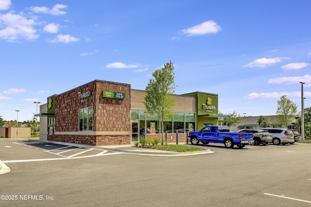 view of property featuring uncovered parking