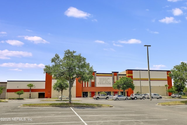 view of building exterior featuring uncovered parking